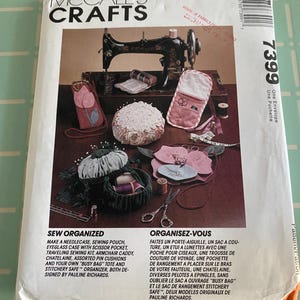 May include: A McCall's Crafts sewing pattern envelope featuring various sewing projects. The cover displays a sewing machine, pincushions, and other sewing accessories. Text includes "Sew Organized" and project descriptions.