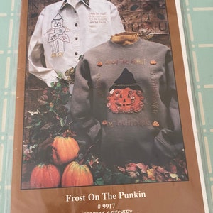 May include: A package featuring a sewing pattern titled "Frost On The Punkin." The cover displays a white shirt and gray sweatshirt with pumpkin and fall-themed embroidery. The text "When The Frost Is On The Punkin" is visible.