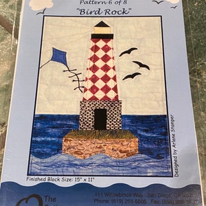 May include: A quilting pattern for a lighthouse with a red and white checkered design, titled "Pieceful Harbor" and "Bird Rock". The pattern is designed by Arlene Stamper and is part of a series of 8 patterns. The finished block size is 15 inches by 11 inches.