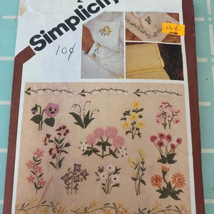 May include: A vintage Simplicity sewing pattern with the number 9891 and a price of £2.50. The pattern is for embroidery and features a variety of floral designs. The pattern is labelled "10¢" and "One Size".