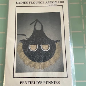 May include: A black and white polka dot apron with a ruffled yellow trim and two pockets. The pattern is called "Ladies Flounce Apron #101" and is from "Penfield's Pennies, Patterns of the Past by Evelyn Penfield."