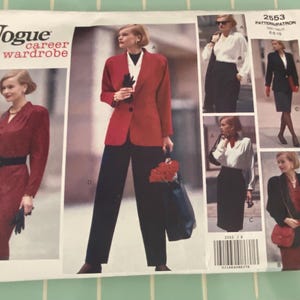 May include: Vogue career wardrobe sewing pattern showing a woman in business outfits. The pattern includes a red blazer, black trousers, and a red dress. The pattern number is 2553.