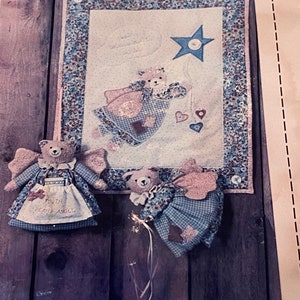 May include: Two handmade plush teddy bear angels with wings and dresses. One angel is holding a star and the other is holding a banner that says "You're My Little Angel".