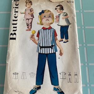May include: Vintage sewing pattern for a child's outfit. The pattern is for a dress with a Peter Pan collar and a pair of pants. The pattern is from Butterick and is size 19. The pattern is priced at 49 cents.