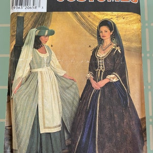 May include: Simplicity Costumes sewing pattern 7756 for sizes 10, 12, and 14. The package displays two historical-style gowns: one in green and cream stripes with a matching headpiece, and another in dark patterned fabric with a blue skirt and veil.
