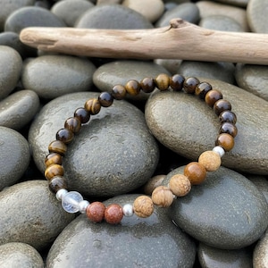 Pulsera elástica minerales 6mm en tonos amarillos representando al arcángel Jofiel, arte y creatividad terminada en plata de ley.