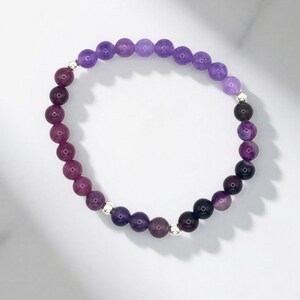 Elastic bracelet with 6mm purple minerals representing Archangel Zadkiel, change and transformation.