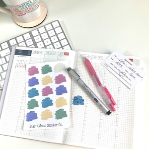 May include: A sheet of colorful stickers with a variety of shapes and colors. The stickers are arranged in rows and columns on a white background. The sheet is labeled "Star + Moon Sticker Co."