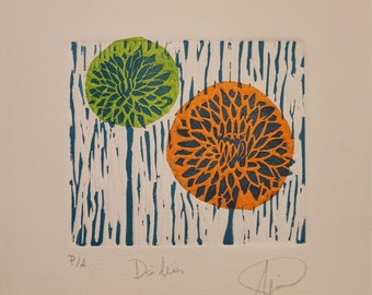 May include: A print of two stylized dahlias in green and orange with a blue and white background. The print is signed "Dahlia" and "P/A".