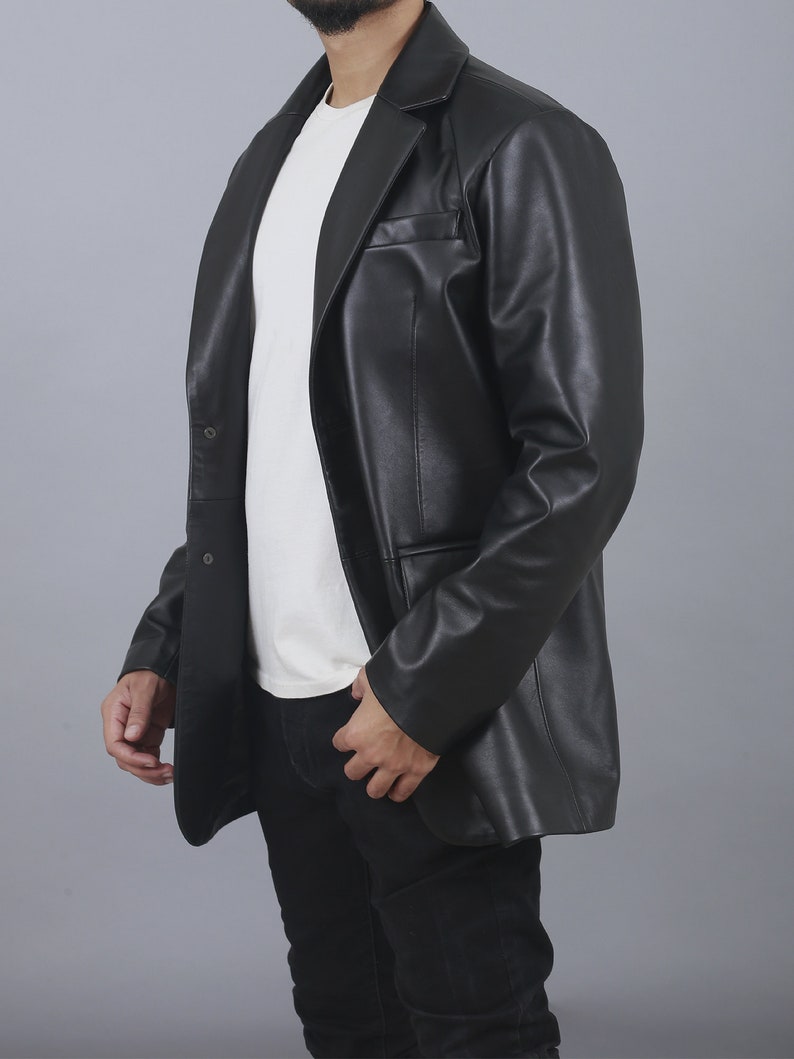 May include: A black leather blazer with a single button fastening and a notched lapel. The blazer has a relaxed fit and a long length.