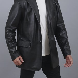 May include: A black leather blazer with a single button closure. The blazer has a classic fit and a notched lapel.
