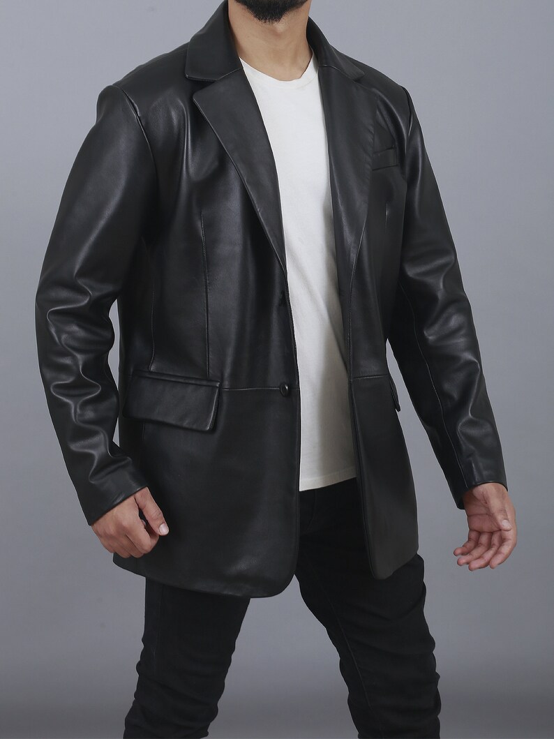 May include: A black leather blazer with a single button closure. The blazer has a classic fit and a notched lapel.