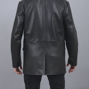 May include: A black leather jacket with a double-breasted closure and long sleeves.