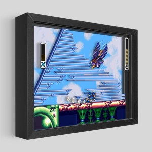 May include: A pixelated video game scene featuring a blue robot character running across a platform with a flying enemy in the background. The scene is set against a blue sky with white clouds. The game's health and energy meters are visible on the sides of the screen.