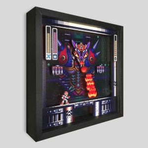 May include: A framed pixel art print of a video game boss fight. A small blue character with a gun is facing a large, red and purple robot with horns and a glowing mouth. The robot is firing a stream of flames at the character. The print is set in a black frame with a dark background.