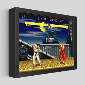 May include: A retro video game screen showing a fight scene from Street Fighter. The characters Ryu and Ken are facing each other on a wooden platform. The text "FIGHT!" is displayed in the center of the screen. The score is 50000 and the player 1 character is KO'd.