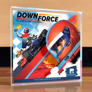 May include: A board game box titled "DOWN FORCE" with a racing theme. The box art features a race car, a helmet, and a driver holding a trophy. The text "THE GAME OF HIGH STAKES SPEED" is also visible. The Restoration Games logo is in the lower right corner.