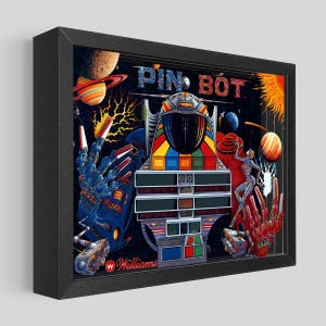 May include: A framed Pin Bot pinball machine art print. The artwork features a colorful space-themed design with planets, a sun, and the text "PIN BOT". The Williams logo is visible at the bottom.