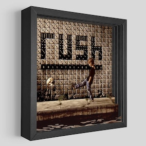 May include: A black and white album cover with a child kicking a skull towards a wall with the word "TUSH" spelled out in black letters on a tiled background. The text "ROLL THE BONES" is below the word "TUSH".