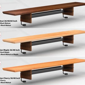 May include: Three wooden tabletops with black metal legs and shelves. The tabletops are made of US Walnut, Canadian Maple, and Canadian Cherry. The tabletops are 36, 48, and 60 inches long.