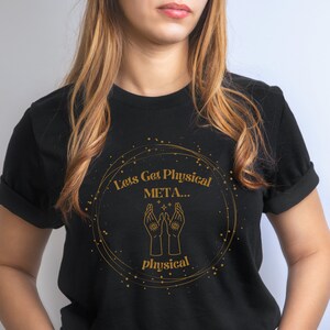 May include: Black t-shirt with a gold circle design featuring the text "Let's Get Physical META... physical".