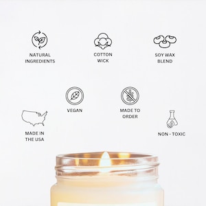 May include: A white candle in a glass jar with a natural soy wax blend, cotton wick, and natural ingredients. The candle is made in the USA and is vegan and non-toxic. It is made to order.