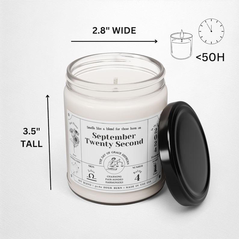 May include: A white candle with a black label that reads "September Twenty Second" and includes astrological symbols. The candle is 3.5 inches tall and 2.8 inches wide. The candle is in a glass jar with a black lid.