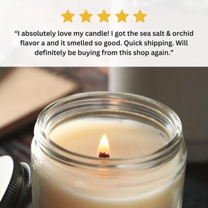 May include: A close-up of a lit candle in a clear glass jar. The candle is a light yellow color and the wax is smooth. The wick is burning and there is a small flame.