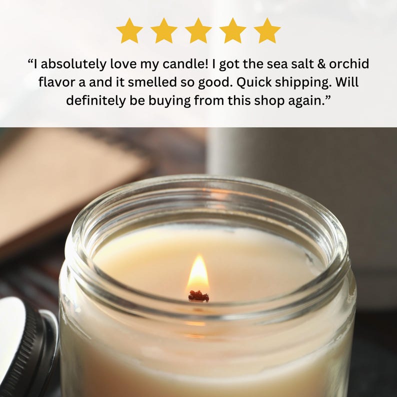 May include: A close-up of a lit candle in a clear glass jar. The candle is a light yellow color and the wax is smooth. The wick is burning and there is a small flame.