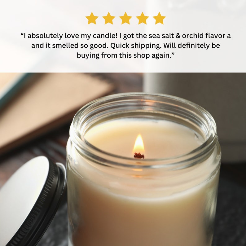 May include: A lit candle in a clear glass jar with a black lid. The candle is a light yellow color and the flame is a bright orange. The candle is sitting on a wooden surface.