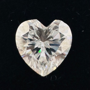 May include: A clear heart-shaped diamond with many facets.