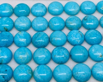 May include: A collection of 36 round turquoise cabochons, each with a unique pattern of blue and white swirls. The cabochons are arranged in rows on a white surface.