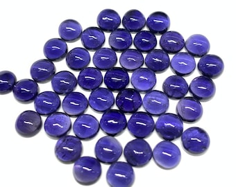 May include: A collection of 40 round, purple amethyst cabochons. The cabochons are smooth and polished, with a slight shimmer.