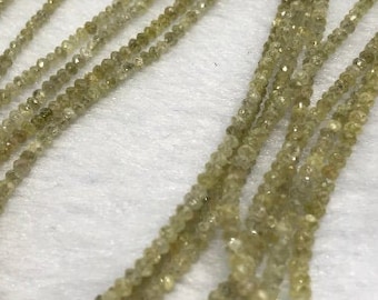 May include: A strand of light green faceted gemstone beads. The beads are small and round, and they are strung on a clear thread. The beads are arranged in a loose, flowing pattern.