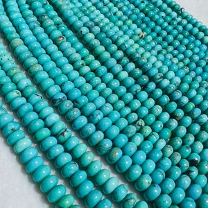 May include: A strand of turquoise beads, each bead is a light blue color with dark blue and brown veins. The beads are round and smooth, and they are strung together on a clear thread.