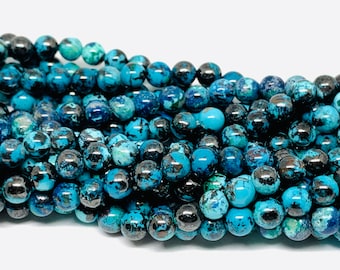 May include: A strand of round, blue and black gemstone beads. The beads have a mottled, marbled appearance.