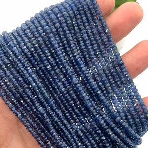 May include: A strand of deep blue sapphire beads, faceted and round, strung together for jewellery making. The beads are uniform in size and have a polished, lustrous finish.