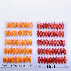 May include: Two sets of oval-shaped beads in orange and red, each arranged on a white card. The orange beads are labeled "Orange" and the red beads are labeled "Red". Each bead measures 6x16mm. The cards are labeled "50PCS".