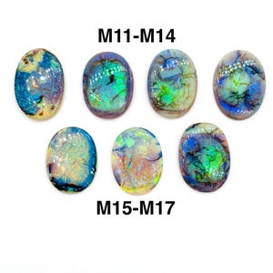 May include: Seven oval-shaped opals with iridescent colors of blue, green, and yellow. The opals are arranged on a white background. The text "M11-M14" and "M15-M17" is printed in black above and below the opals.