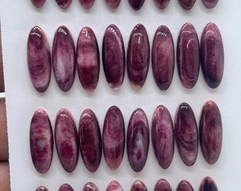 May include: A collection of thirty-two oval-shaped cabochons arranged in four rows of eight. Each piece features a polished, smooth surface with swirling patterns of deep plum, burgundy, and white, creating a marbled appearance across the set.