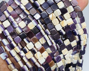 May include: A strand of square-shaped shell beads with a purple, white, and brown marbled pattern.