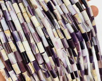 May include: Strands of rectangular beads in shades of purple, white, and cream. The beads have a marbled appearance, with variations in color and pattern. The beads are strung together, creating a flowing, textured look. Ideal for jewelry making.