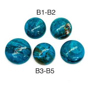 May include: Five round, polished gemstones with a vibrant turquoise color and unique swirling patterns. The gemstones are labeled B1-B2 and B3-B5. The stones have a glossy finish and are set against a white background.