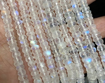 May include: A strand of white moonstone beads with iridescent shimmer. The beads are round and have a smooth, polished finish.