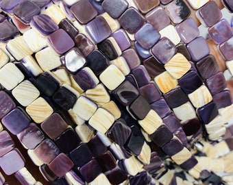 May include: A strand of square-shaped shell beads in shades of purple, white, and brown. The beads are arranged in a random pattern, creating a unique and eye-catching look.