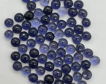 May include: A collection of 50 round, blue gemstone cabochons. The cabochons are smooth and polished, with a slight variation in color from light to dark blue.