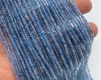 May include: A strand of light blue gemstone beads, approximately 2mm in diameter, with a faceted finish. The beads are strung on a clear thread and are ready for jewelry making.