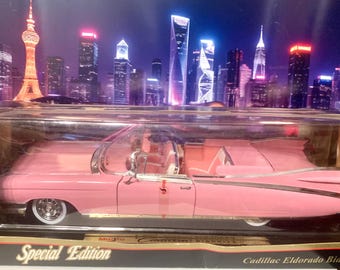 1:18 scale model of a 1959 Cadillac Eldorado Biarritz Convertible Pink Cadillac in original box, seems unopened. Ships free in the USA