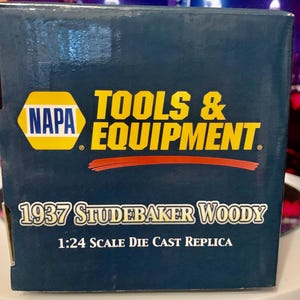 May include: A blue box with a yellow and red NAPA TOOLS & EQUIPMENT logo. The box features a 1:24 scale die cast replica of a 1937 Studebaker Woody.