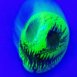 Smile mask with blood splatter painted with fluorescent paints